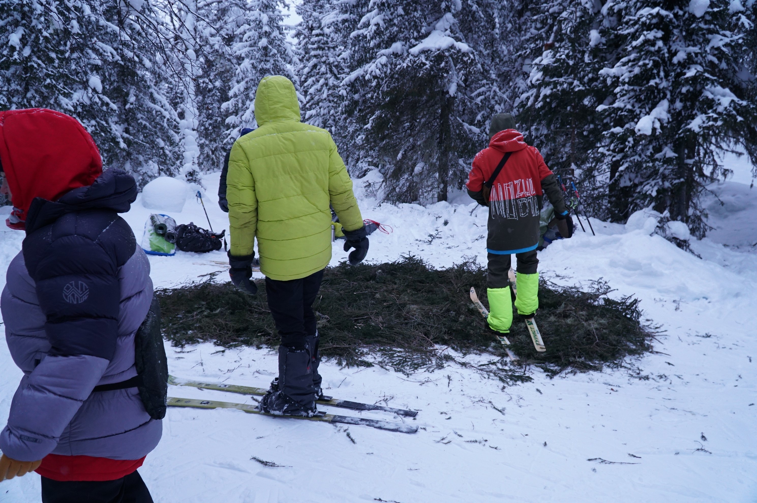 people on skis clearing snow for a fire place