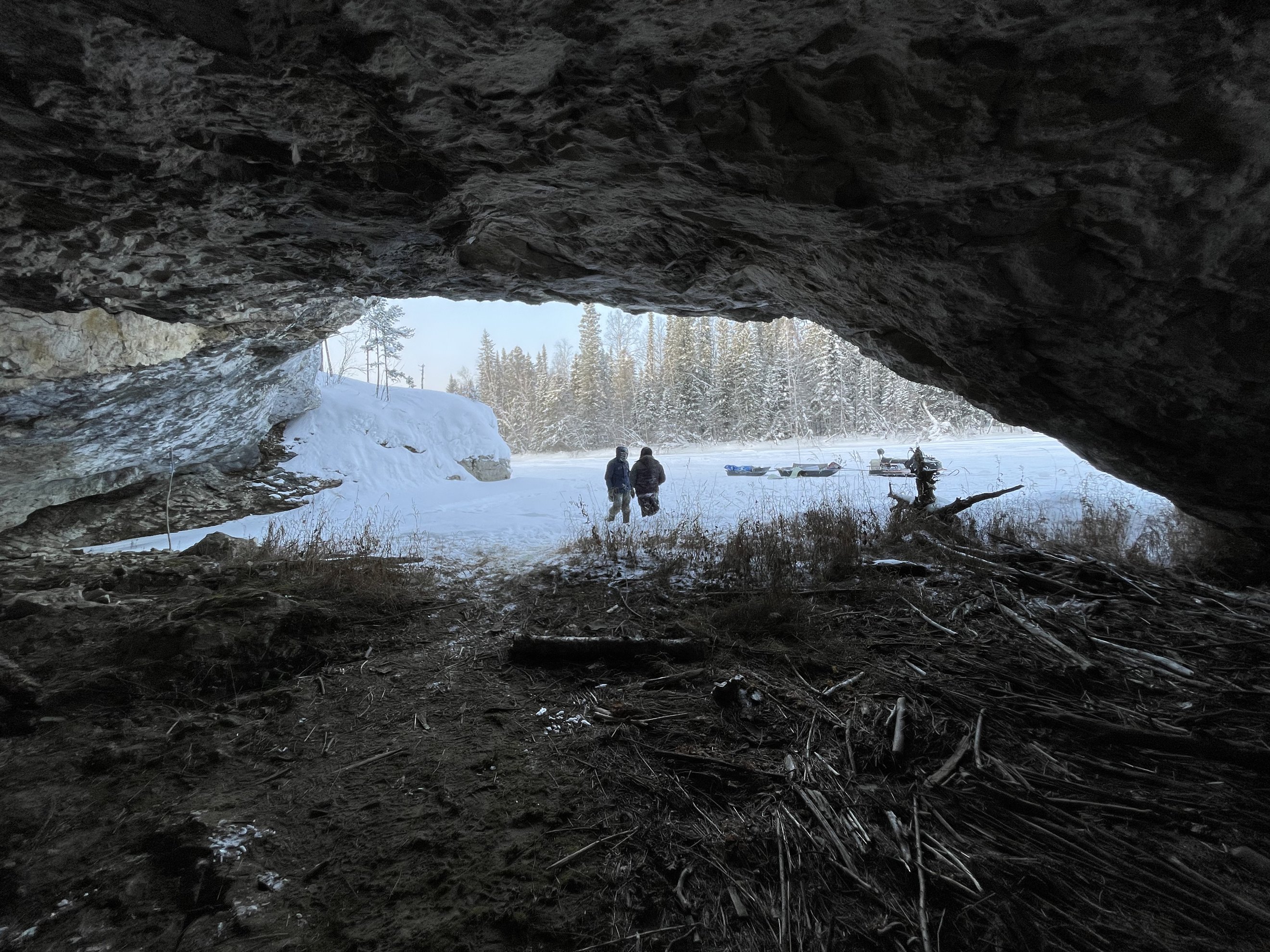 view from inside a small cave next to the river