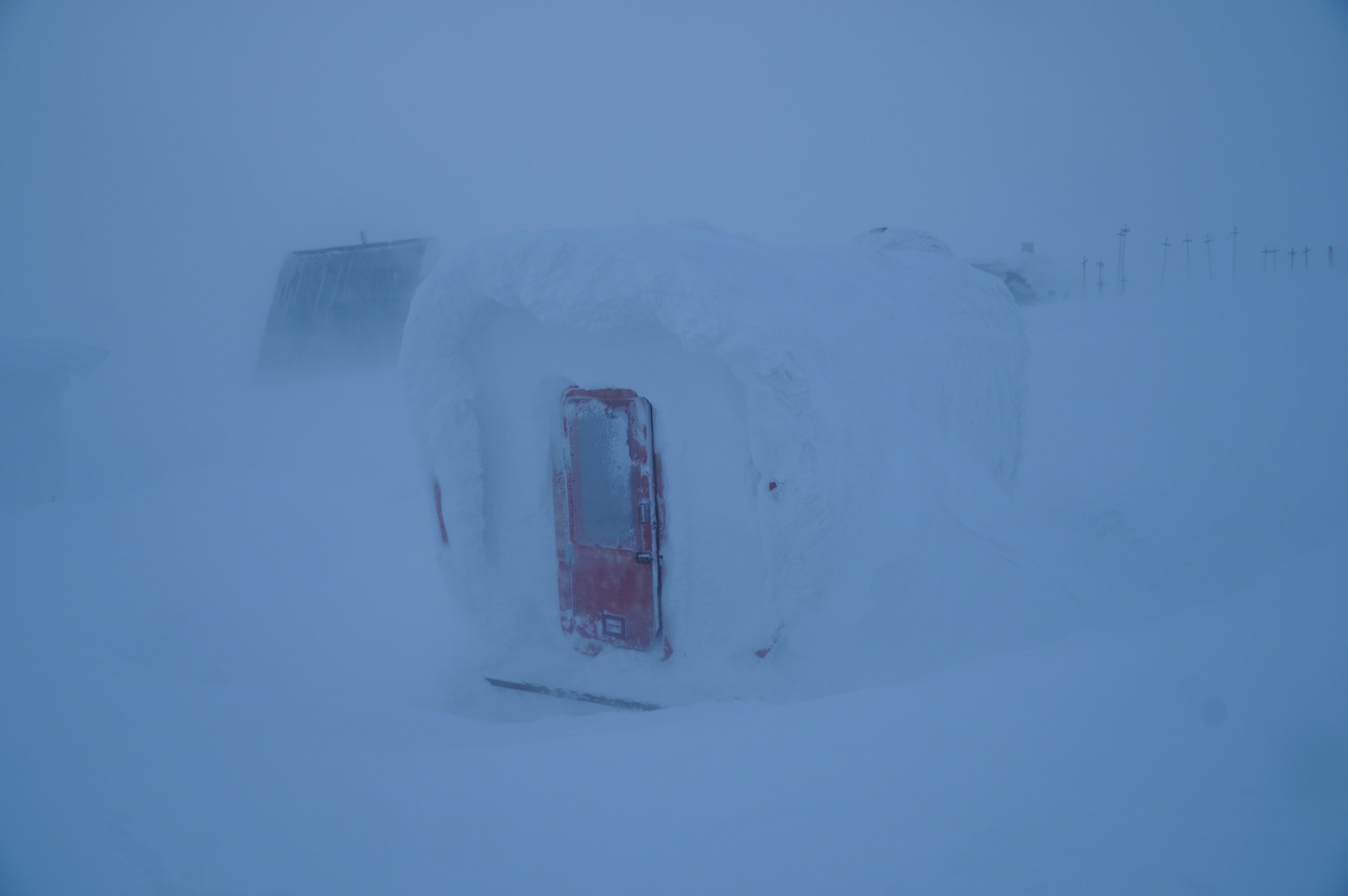 snow-covered mountain module with a red door