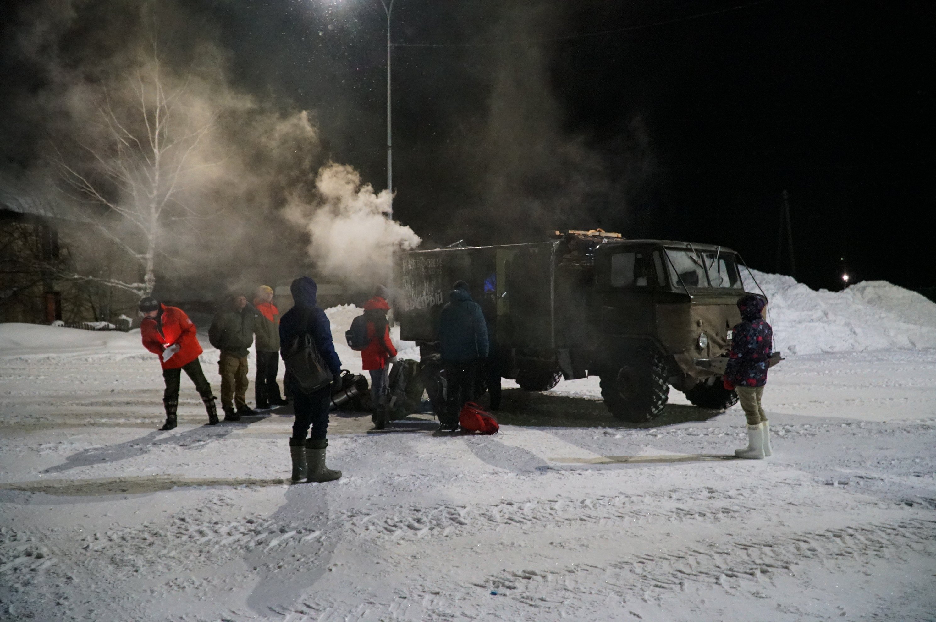 GAZ-66 truck and group meeting in Ivdel at night