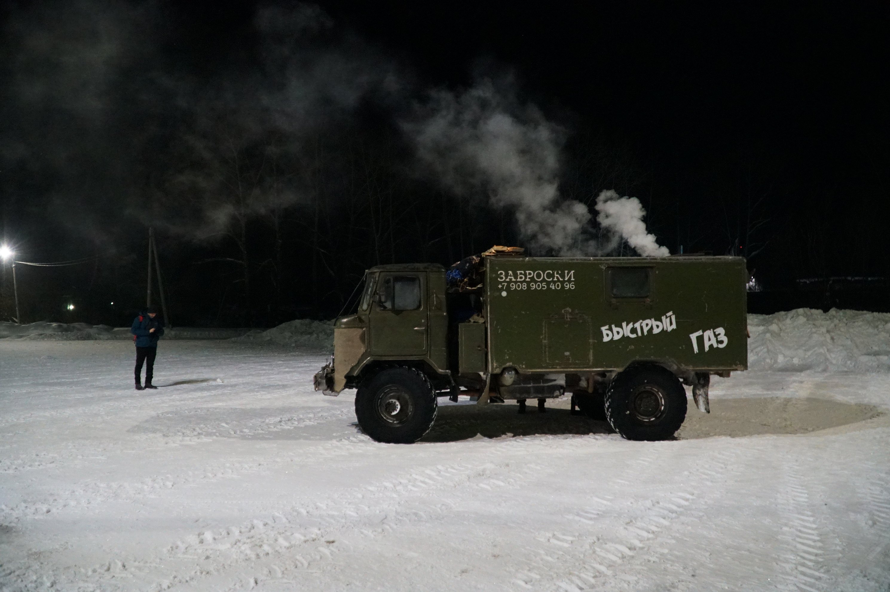 Side view of GAZ-66 vehicle in snow at night