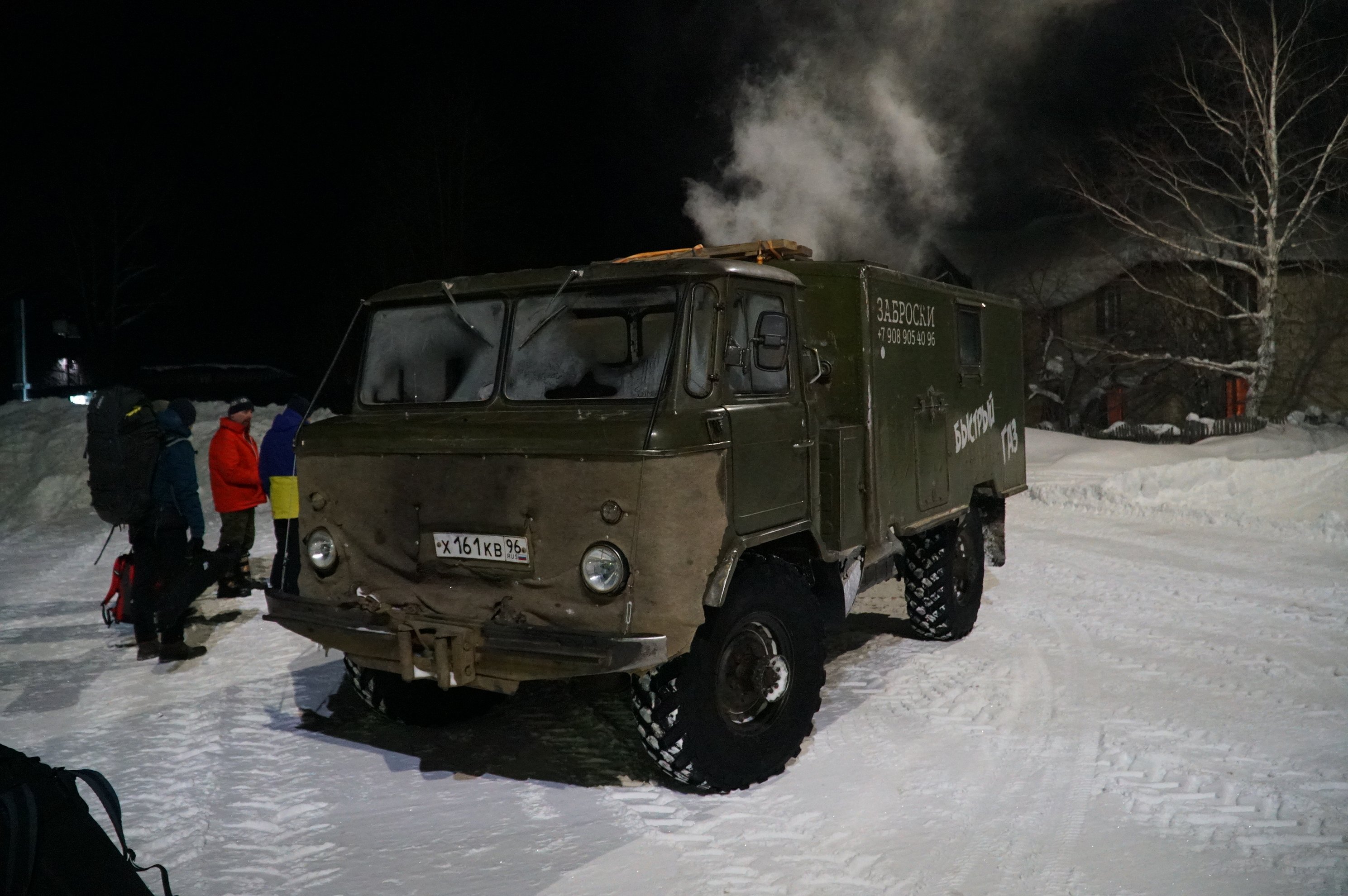 Front view of the GAZ-66 truck parked in snow at night