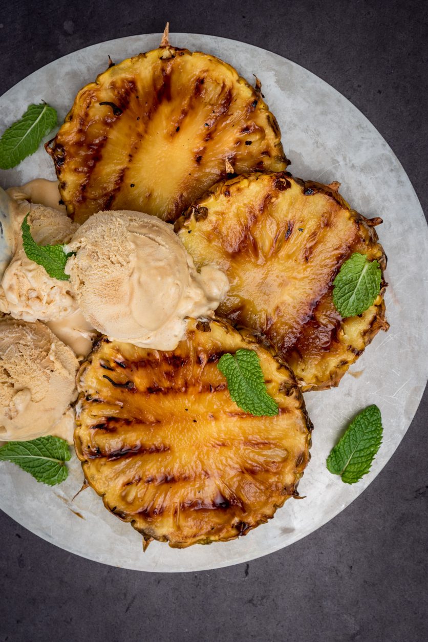 top down view of pineapple slices and ice cream scoops