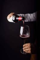 wine pouring from bottle into glass