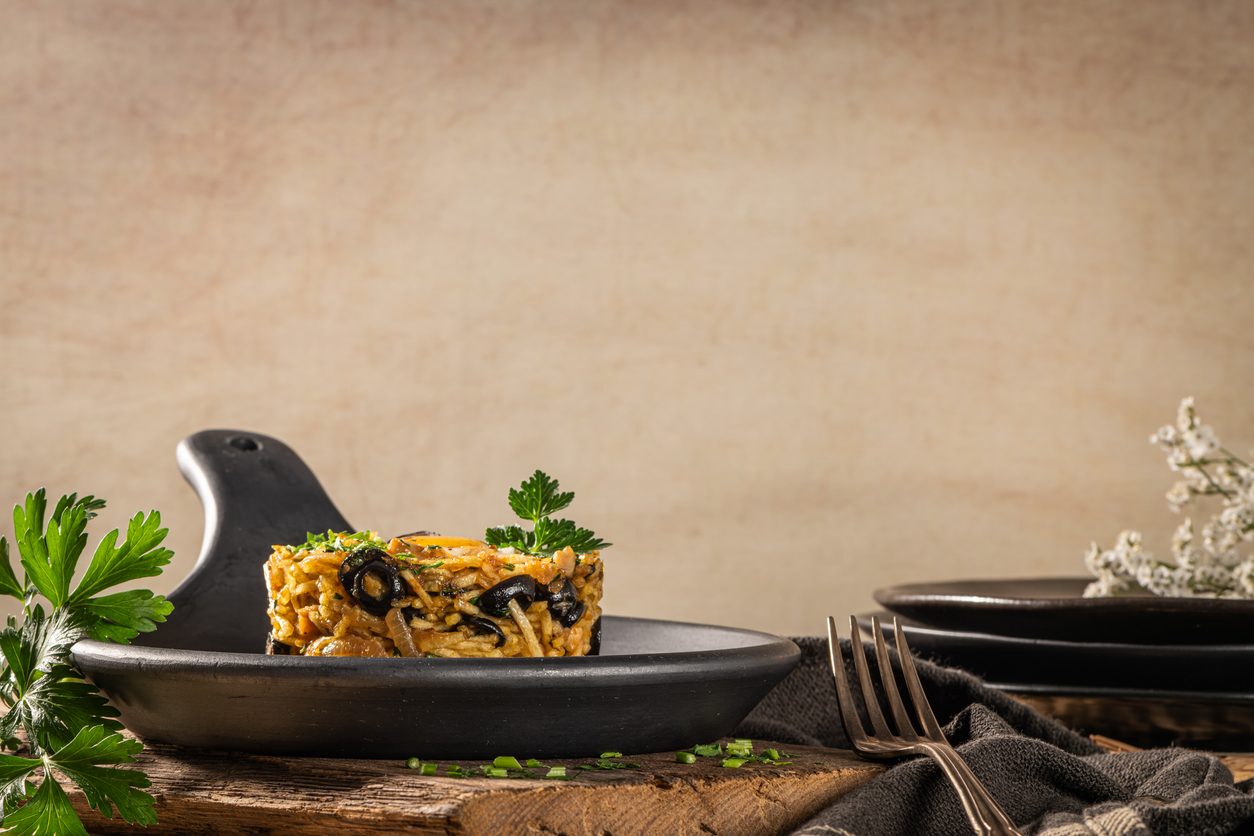 Dish served in a black pan on a wooden surface