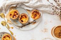 top view of three tarts on a plate with vanilla pods