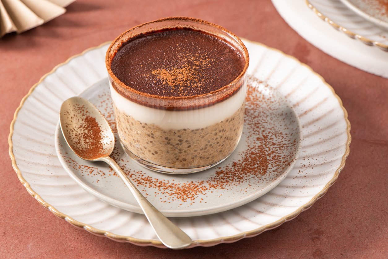 Side view of layered pudding in glass on a plate