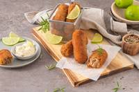 Croquettes served in a mini fryer basket and on parchment paper