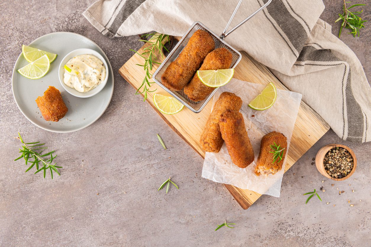 top down view of croquettes in fryer basket and board