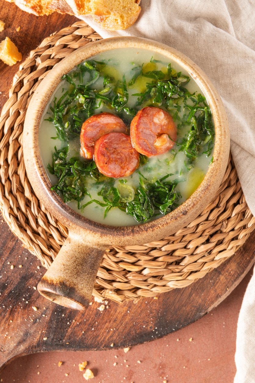 Top-down view of soup in bowl on woven coaster