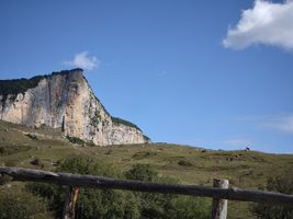 view of the rock face from a grassy slope