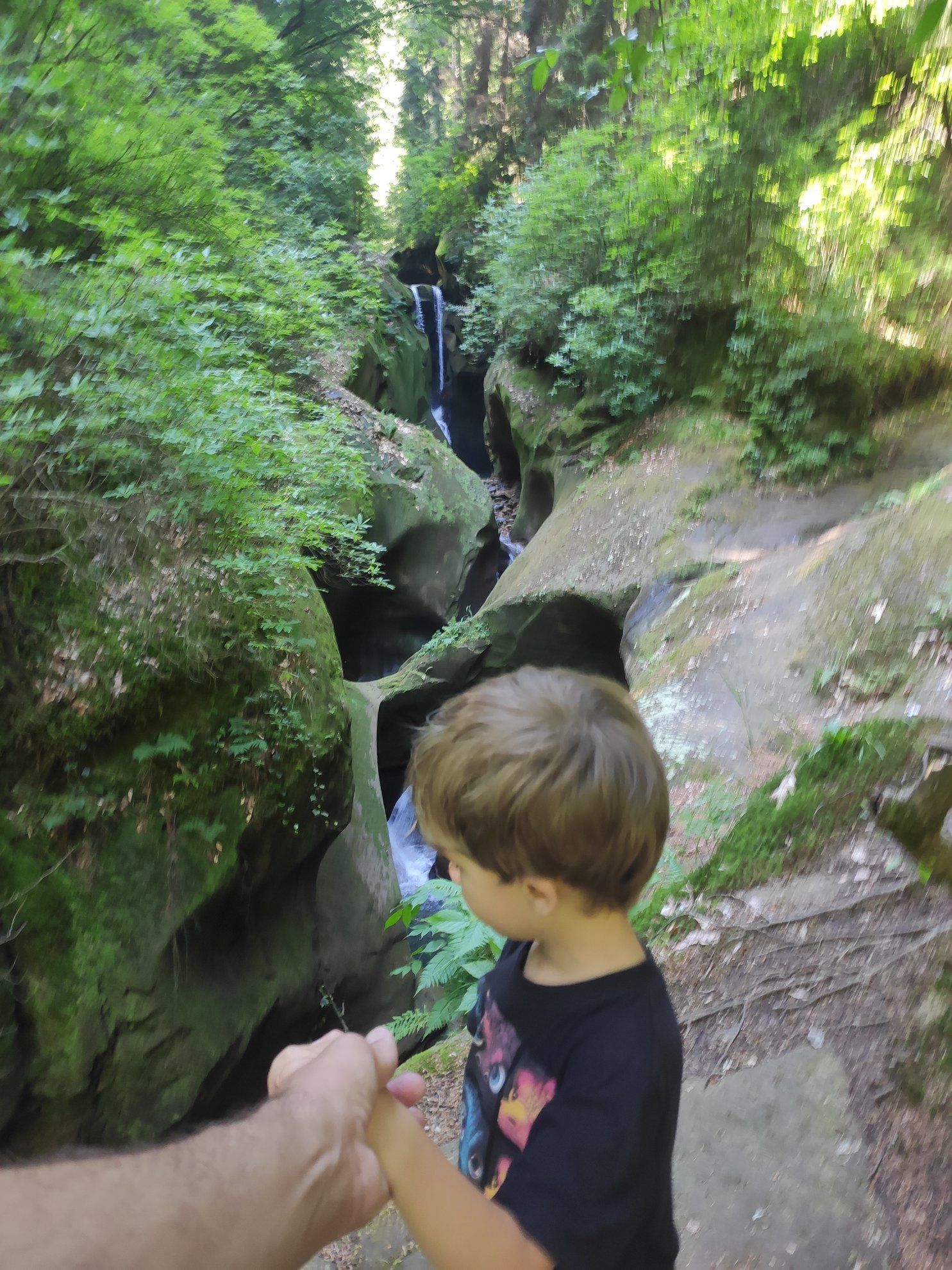 View of a waterfall inside a narrow rocky canyon