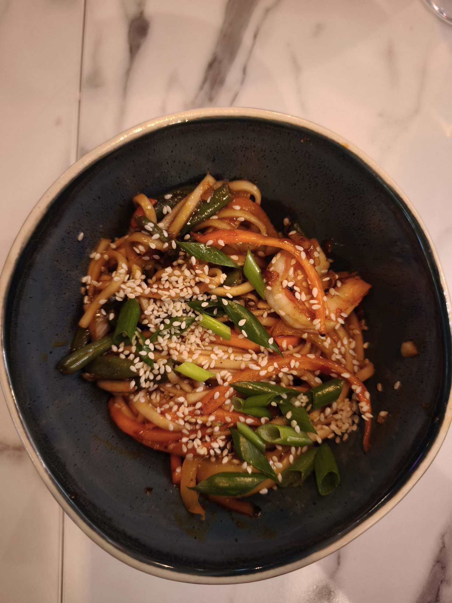 top view of noodles with sesame seeds and green onions