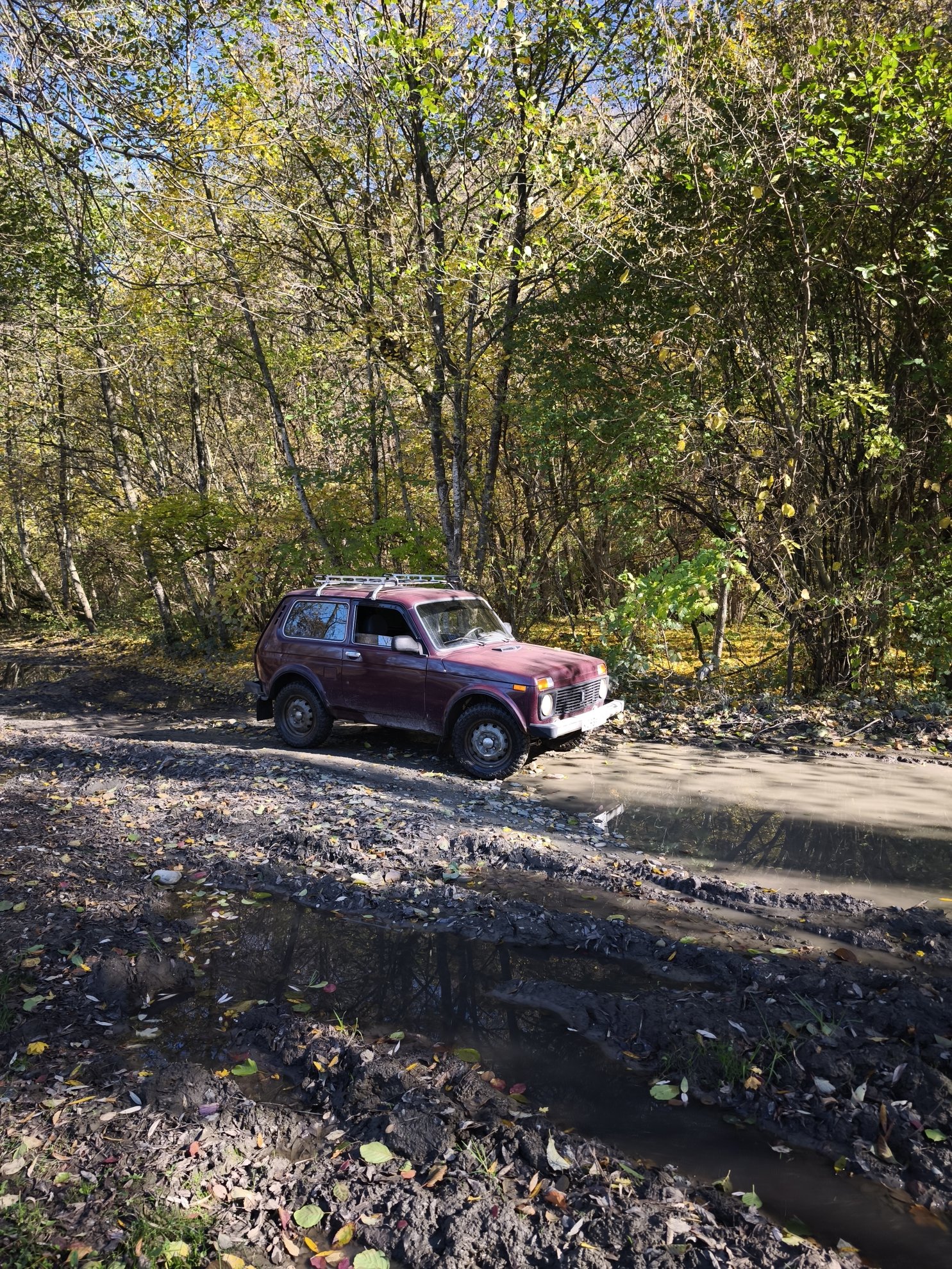 4x4 vehicle on a muddy road with puddles
