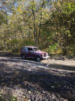 4x4 vehicle on a muddy road with puddles