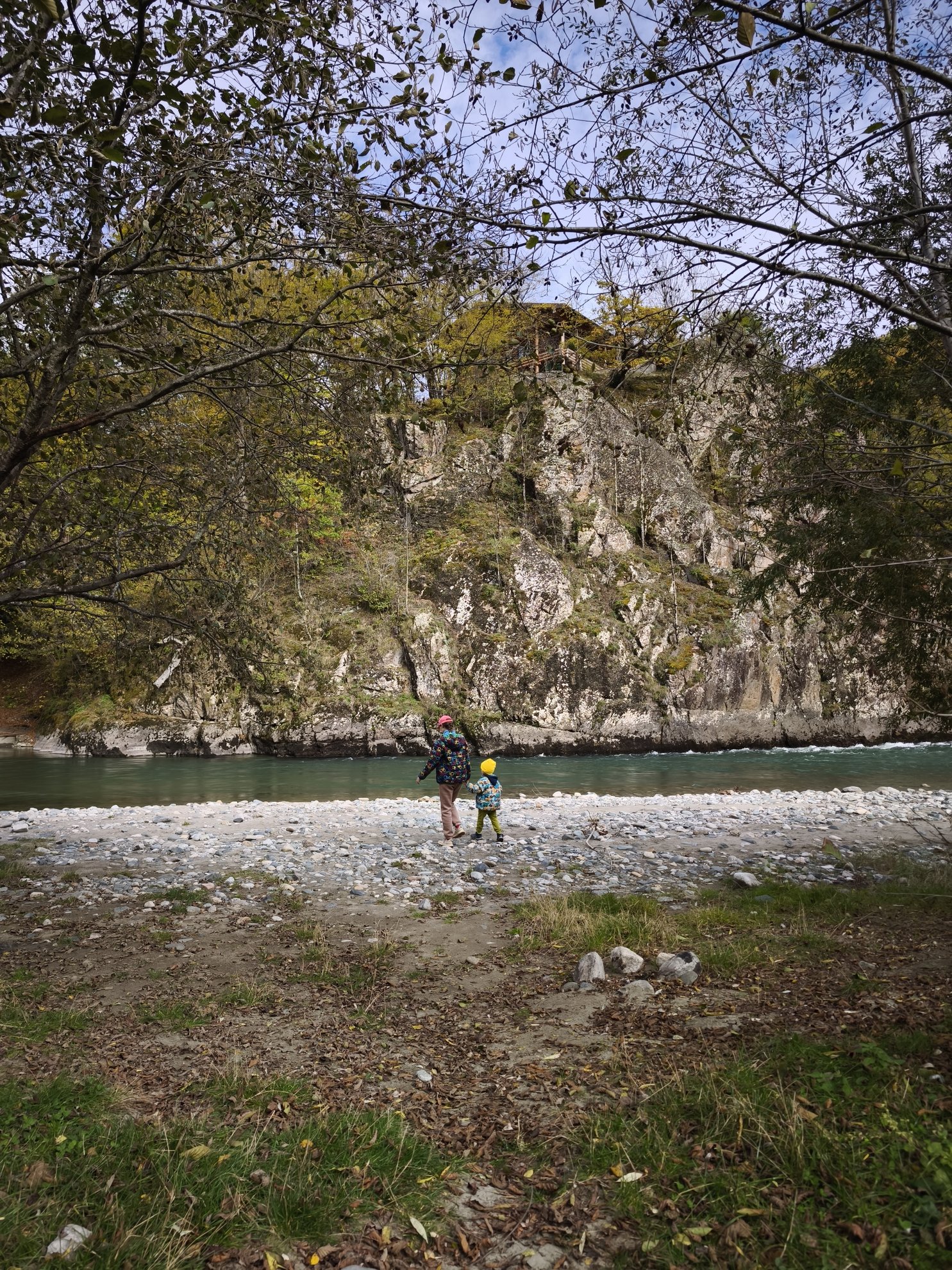 river bank with stony shore and rock wall